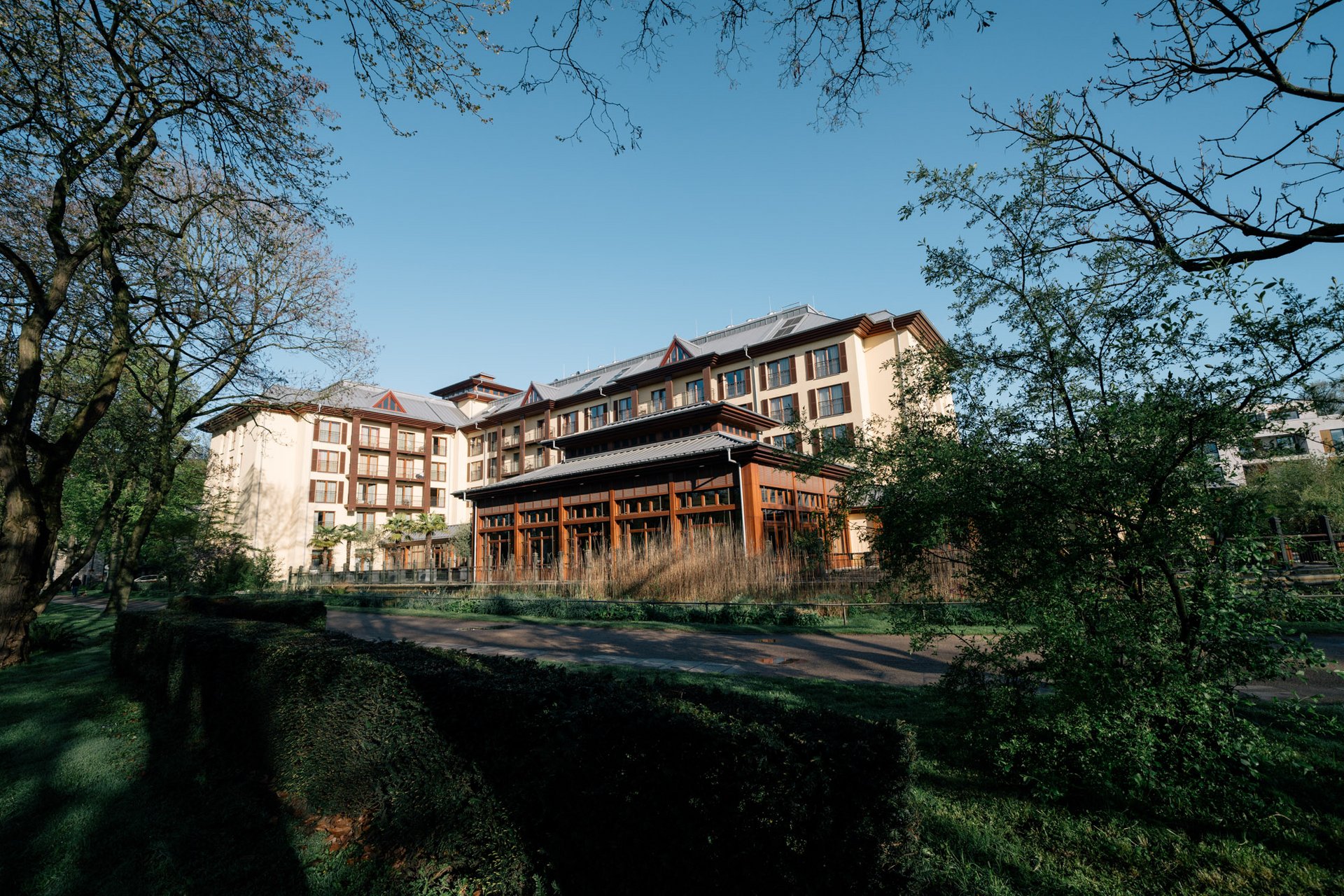 Exterior view of Park-Hotel Hagenbeck – located next to Hagenbeck Zoo in Hamburg, surrounded by lush greenery
